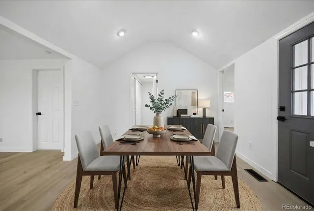 a dining room with furniture and wooden floor