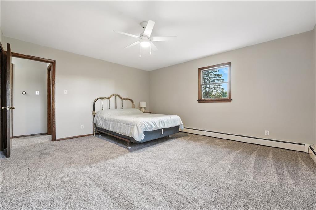 257 Halltown Road Wampum, PA 16157 - Photo 5 of 9 a spacious bedroom with a bed and a chandelier
