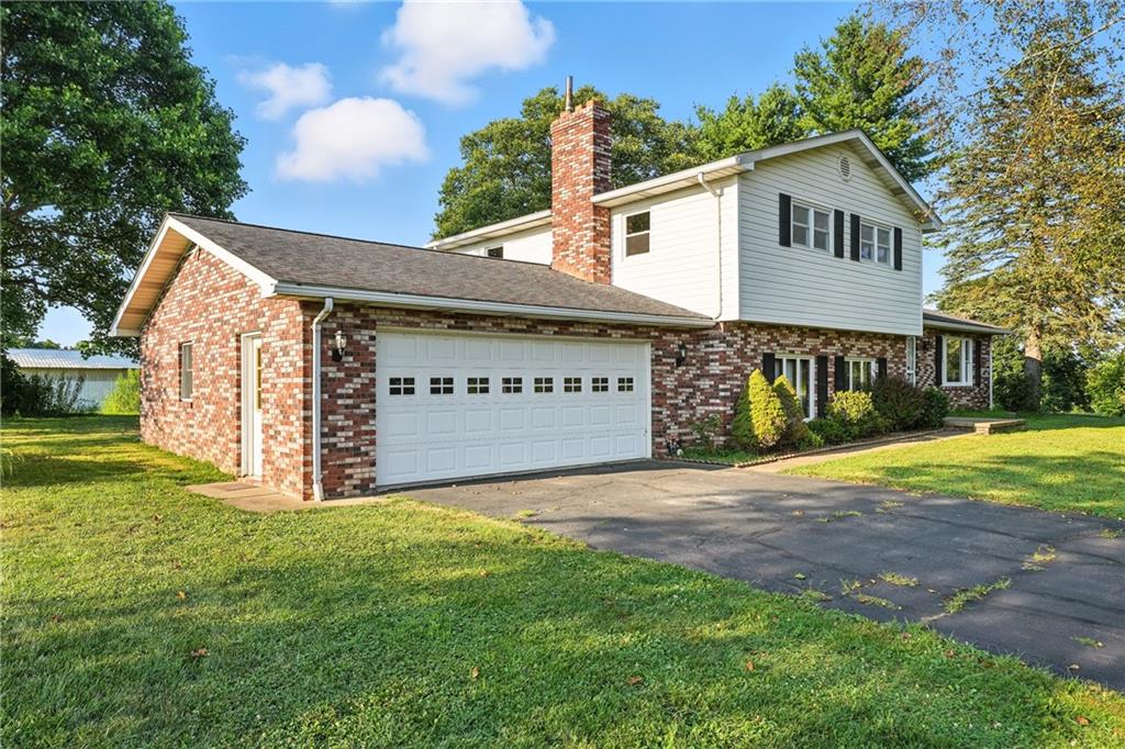 257 Halltown Road Wampum, PA 16157 - Photo 8 of 9 a view of a house with a yard and garage