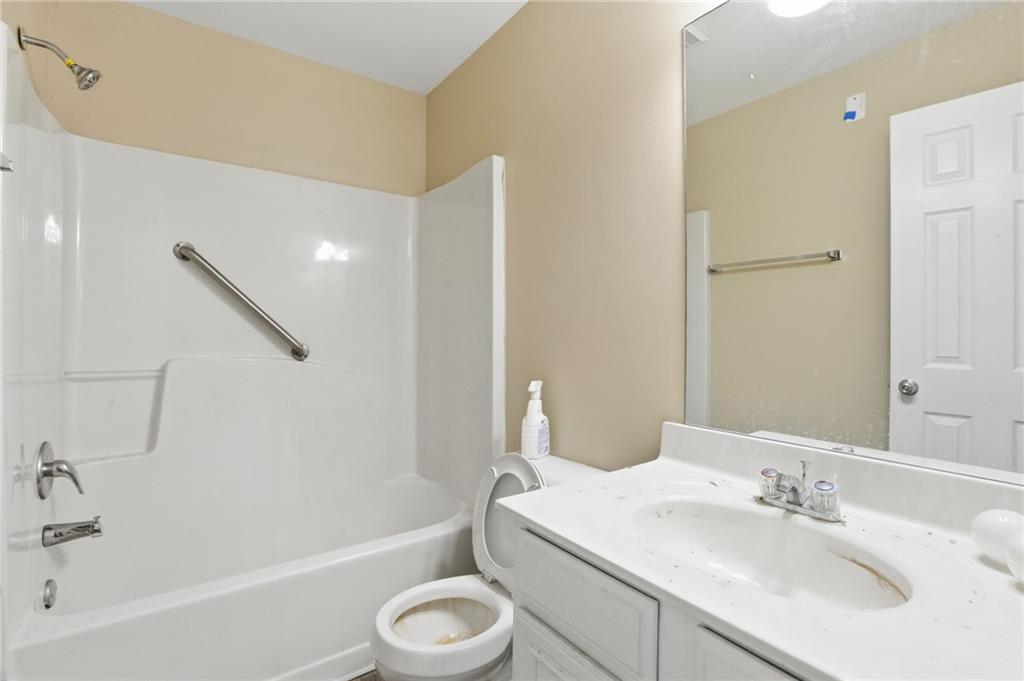 4968 Locherby Drive Fairburn, GA 30213 - Photo 34 of 39 a bathroom with a sink a toilet and shower