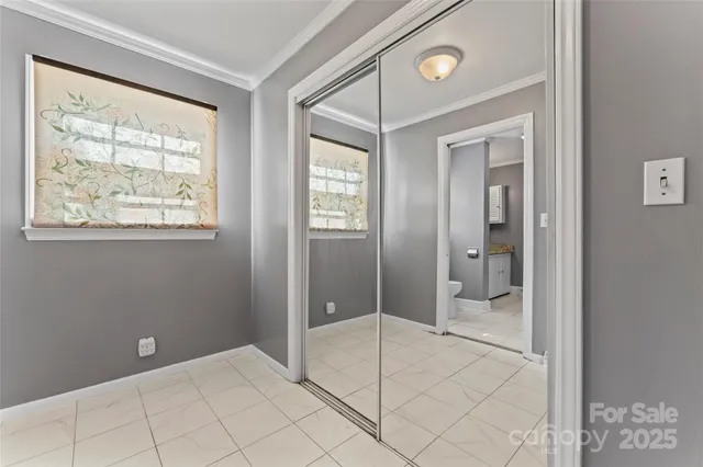 a bathroom with a glass shower door and a window