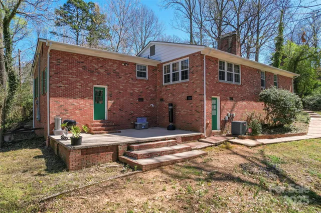 a backyard of a house with yard and outdoor seating
