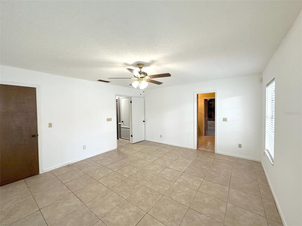 5061 Barnegat Point Road Orlando, FL 32808 - Photo 14 of 33 a view of a livingroom with a ceiling fan