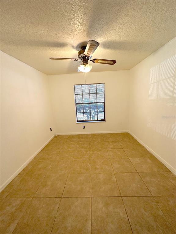 5061 Barnegat Point Road Orlando, FL 32808 - Photo 19 of 33 a view of a big room with windows and chandelier fan