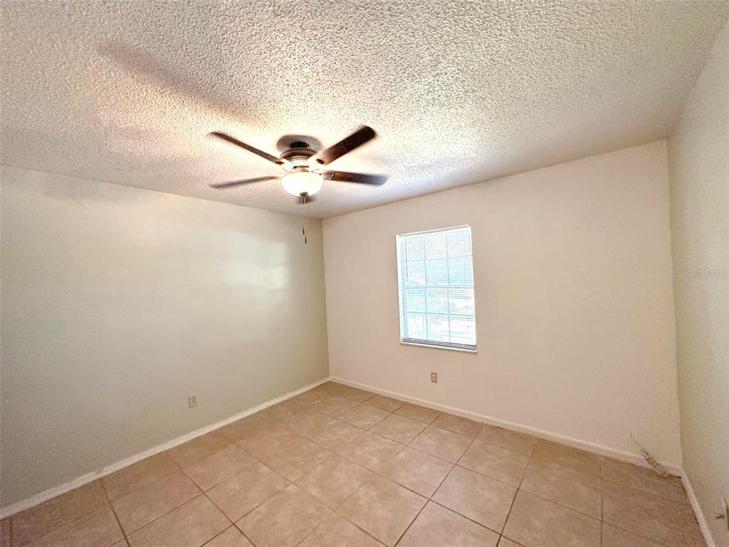 5061 Barnegat Point Road Orlando, FL 32808 - Photo 20 of 33 an empty room with windows and fan