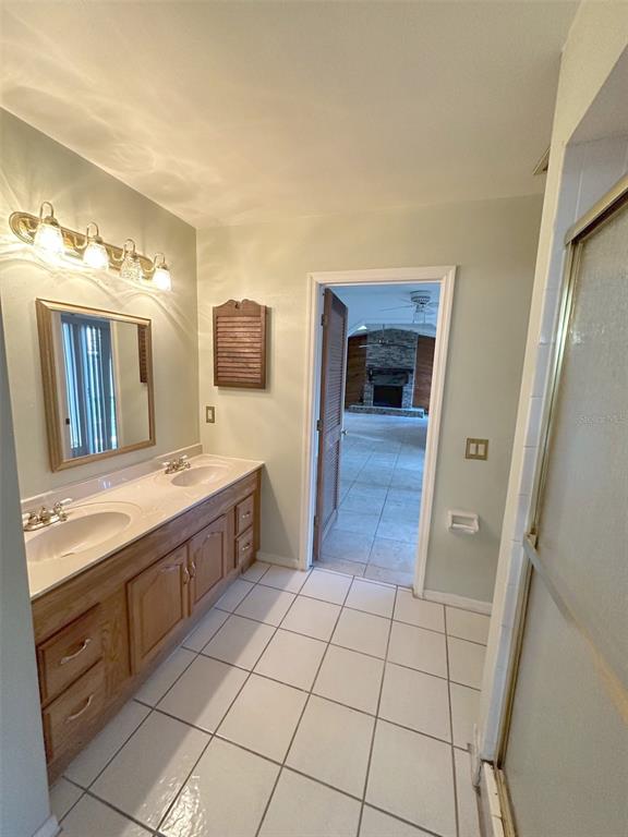 5061 Barnegat Point Road Orlando, FL 32808 - Photo 23 of 33 a large bathroom with a mirror and a sink