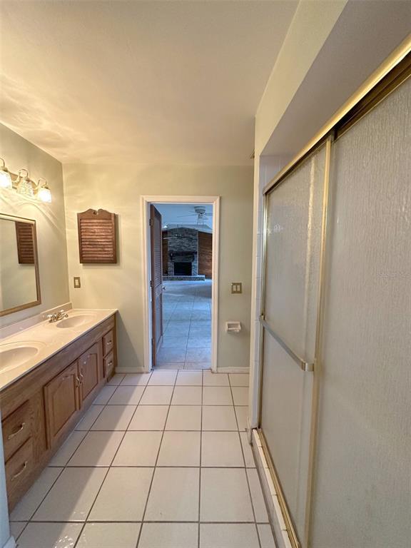 5061 Barnegat Point Road Orlando, FL 32808 - Photo 24 of 33 a bathroom with a sink a mirror and a bathtub
