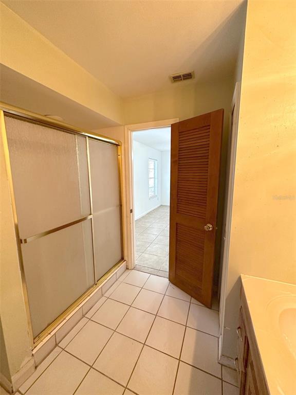5061 Barnegat Point Road Orlando, FL 32808 - Photo 25 of 33 a view of a refrigerator in kitchen and an empty room