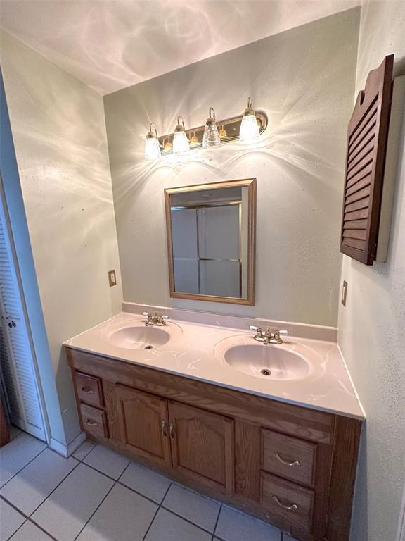 5061 Barnegat Point Road Orlando, FL 32808 - Photo 26 of 33 a bathroom with a sink and a mirror