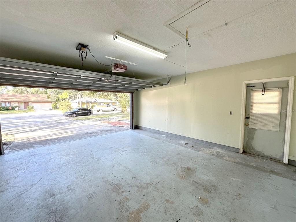 5061 Barnegat Point Road Orlando, FL 32808 - Photo 30 of 33 a view of a kitchen with a refrigerator and windows
