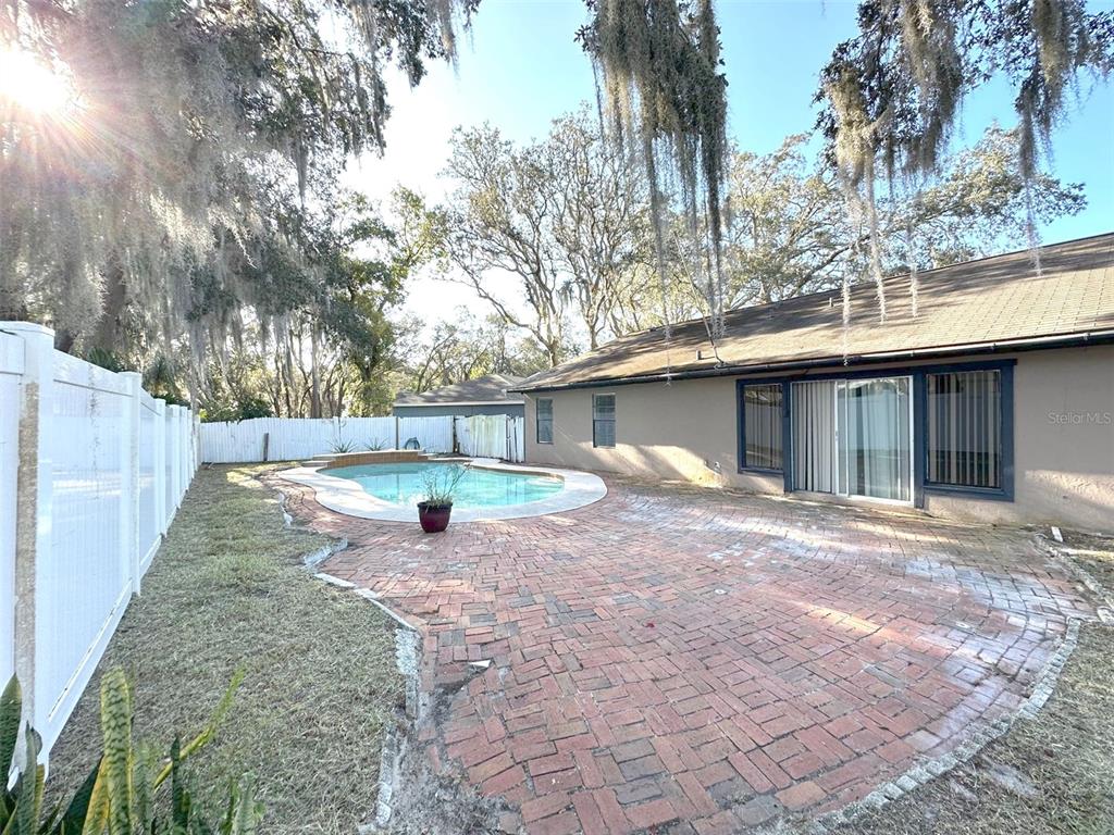 5061 Barnegat Point Road Orlando, FL 32808 - Photo 32 of 33 a view of a yard with a house and a tree