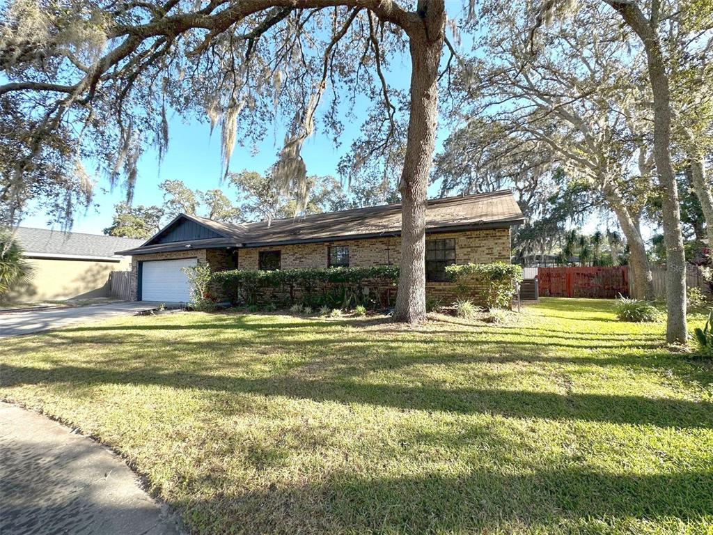 5061 Barnegat Point Road Orlando, FL 32808 - Photo 33 of 33 a front view of a house with a yard table and chairs