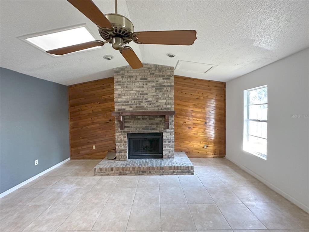 5061 Barnegat Point Road Orlando, FL 32808 - Photo 5 of 33 a view of a livingroom with a fireplace and window