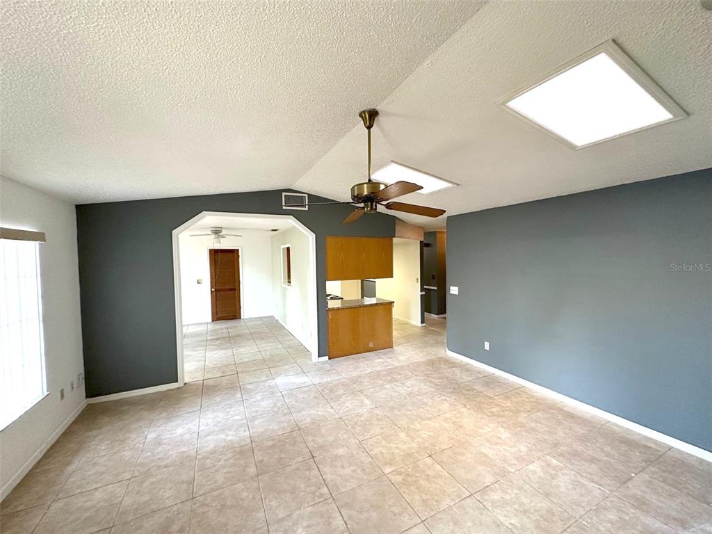 5061 Barnegat Point Road Orlando, FL 32808 - Photo 6 of 33 a view of a livingroom with a fireplace and window