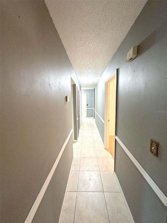 5061 Barnegat Point Road Orlando, FL 32808 - Photo 10 of 33 a view of hallway with a large window
