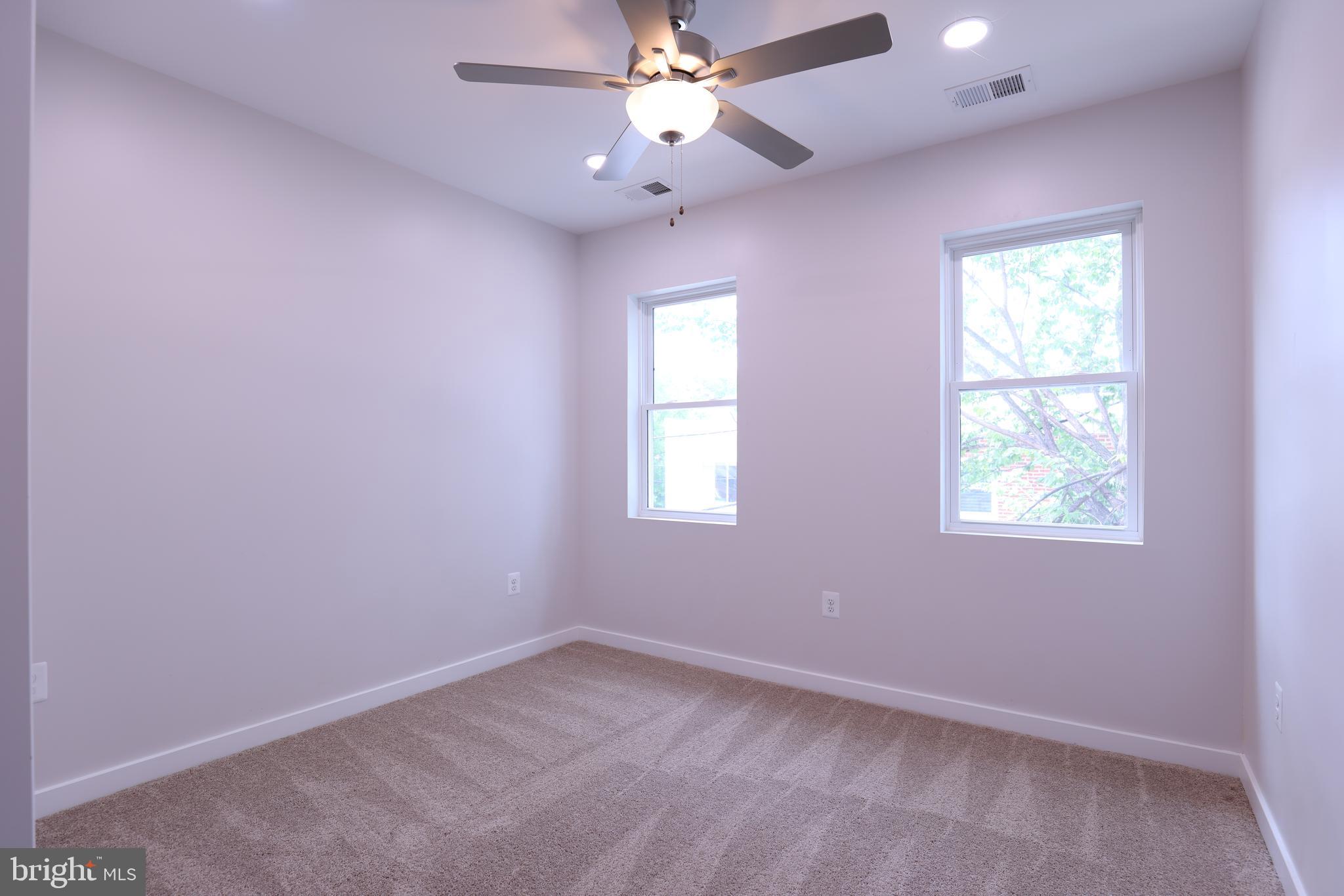 2039 Rosedale Street Northeast Washington, DC 20002 - Photo 15 of 18 an empty room with a window and a fan
