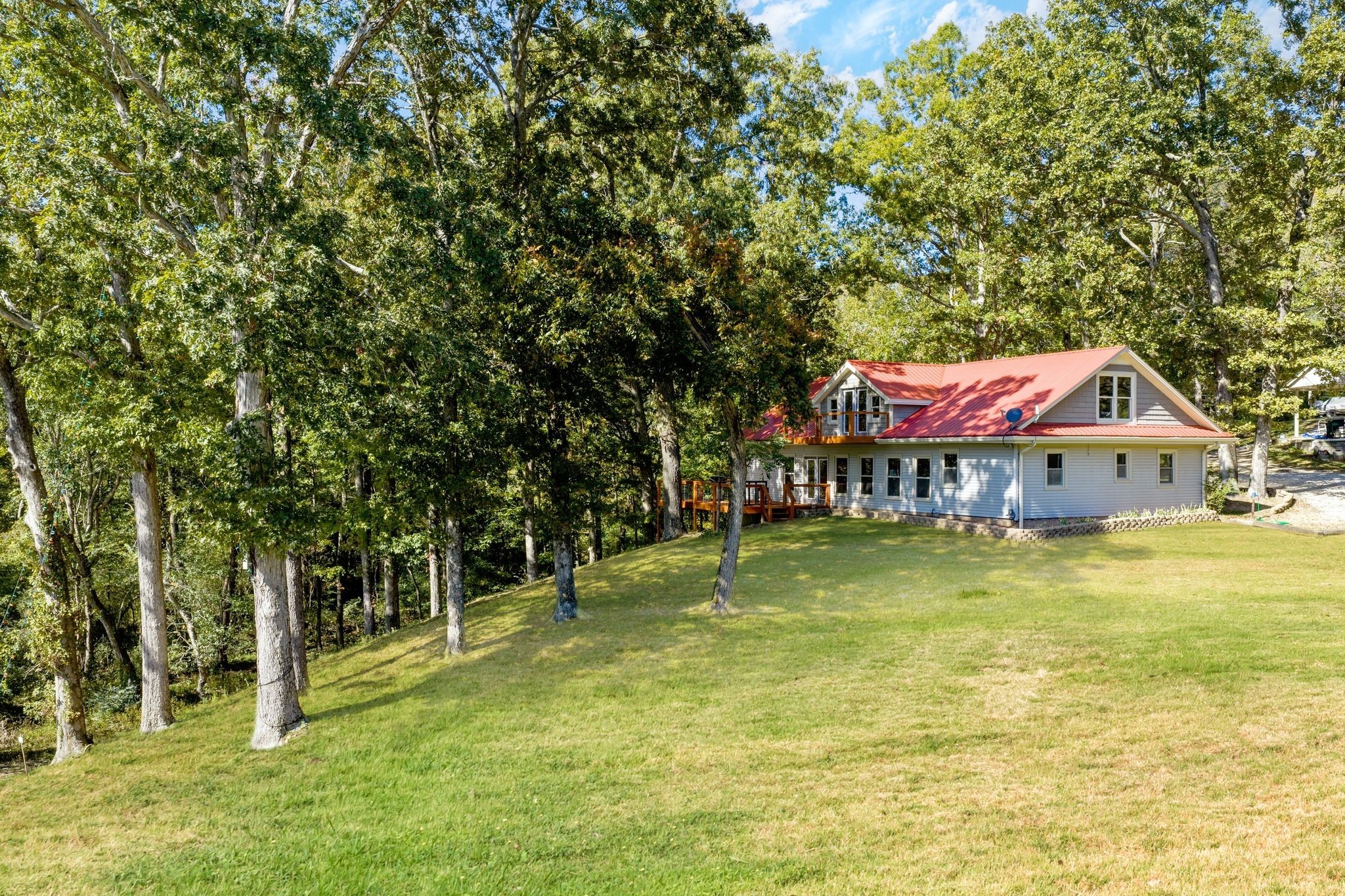 90 Bluff Point Lane Waverly, TN 37185 - Photo 2 of 60 a backyard of a house with swimming pool and large trees