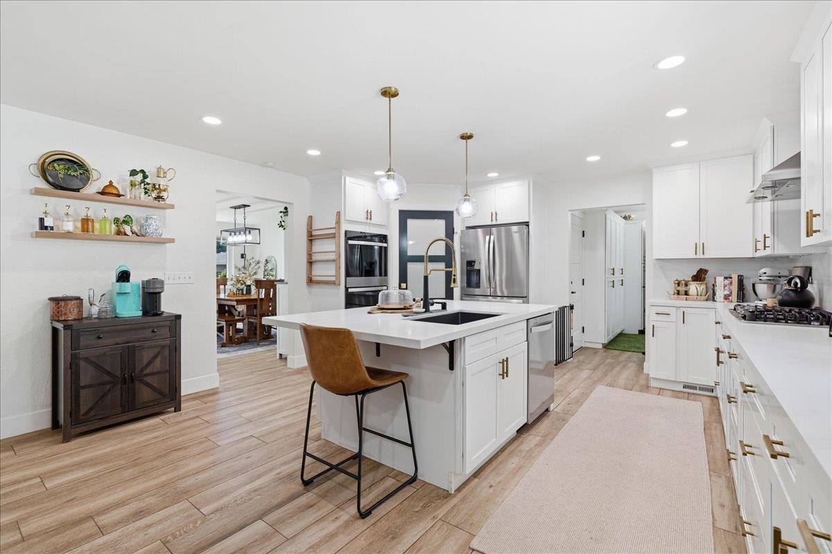 4849 Alexon Way Carmichael, CA 95608 - Photo 14 of 50 a kitchen with stainless steel appliances kitchen island granite countertop a sink and cabinets