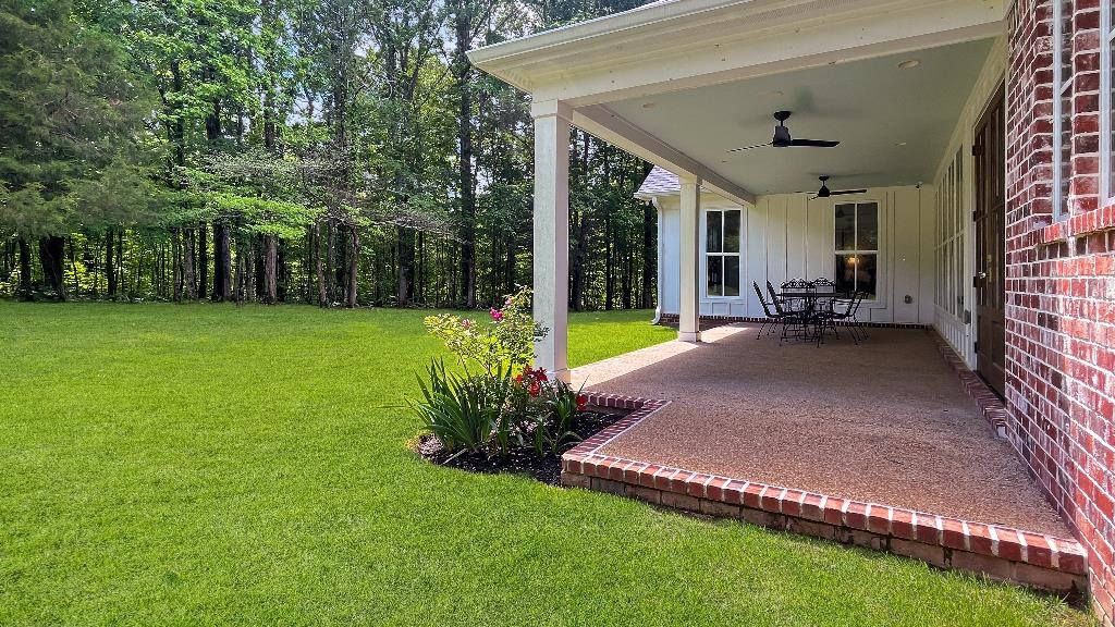 335 Blain Road Rossville, TN 38066 - Photo 36 of 38 a view of a patio with table and chairs potted plants and large tree
