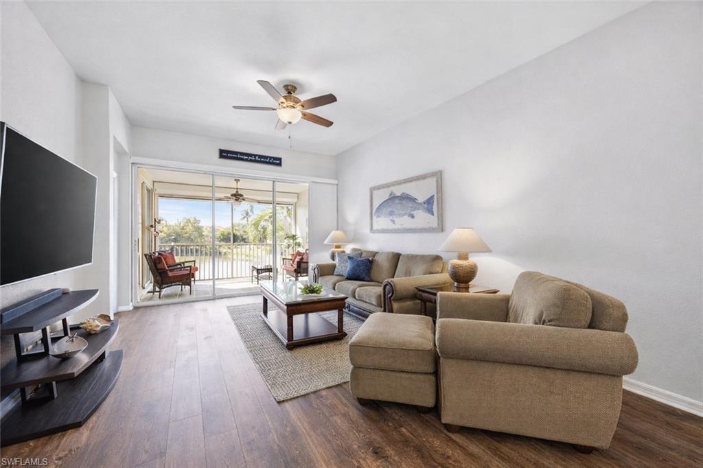 10801 Halfmoon Shoal Road, Unit 203 Estero, FL 34135 - Photo 14 of 50 a living room with furniture and a flat screen tv