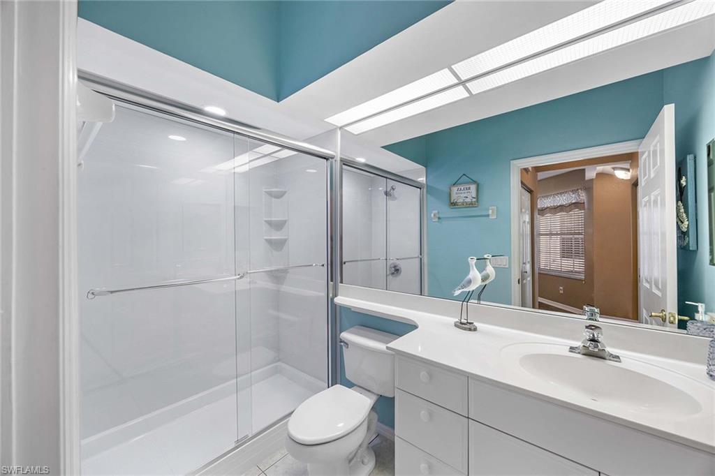 10801 Halfmoon Shoal Road, Unit 203 Estero, FL 34135 - Photo 28 of 50 a bathroom with a sink mirror toilet and shower