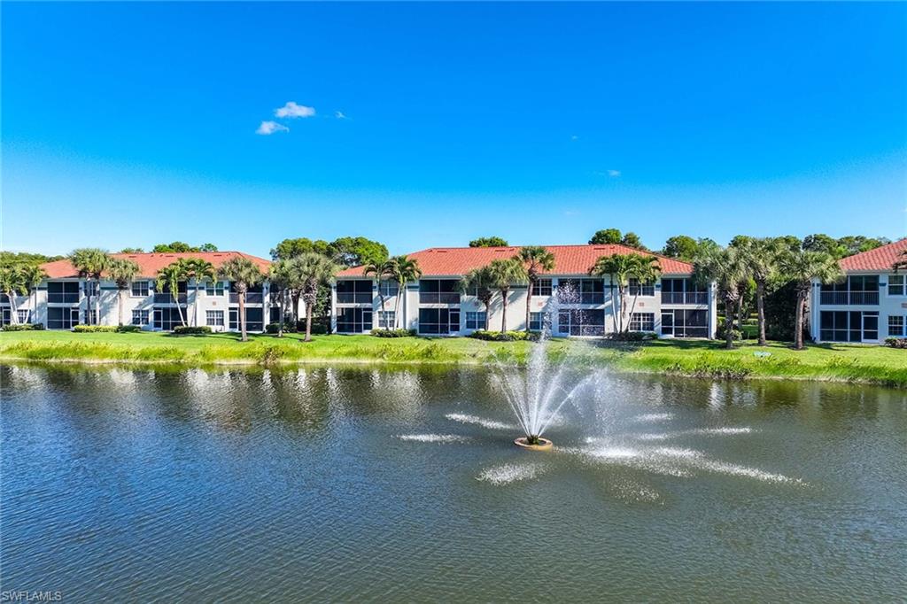 10801 Halfmoon Shoal Road, Unit 203 Estero, FL 34135 - Photo 40 of 50 a view of pool with a house in the background