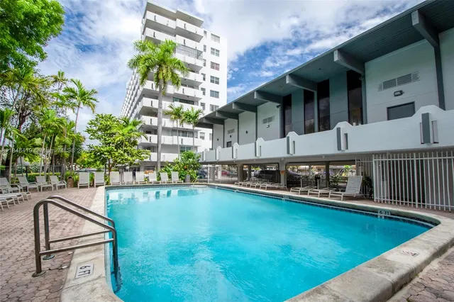 a view of a house with swimming pool and sitting area