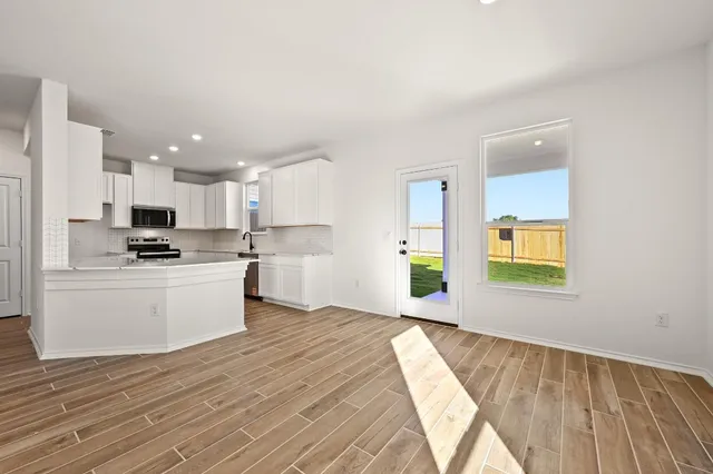 a kitchen with a refrigerator and a stove top oven