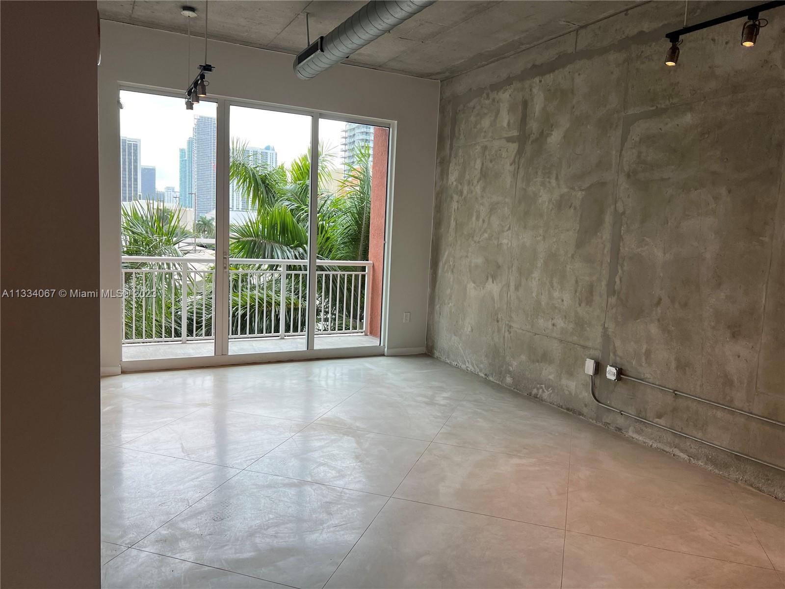 2001 Biscayne Boulevard, Unit 2503 Miami, FL 33137 - Photo 2 of 22 a view of a porch with a floor to ceiling window