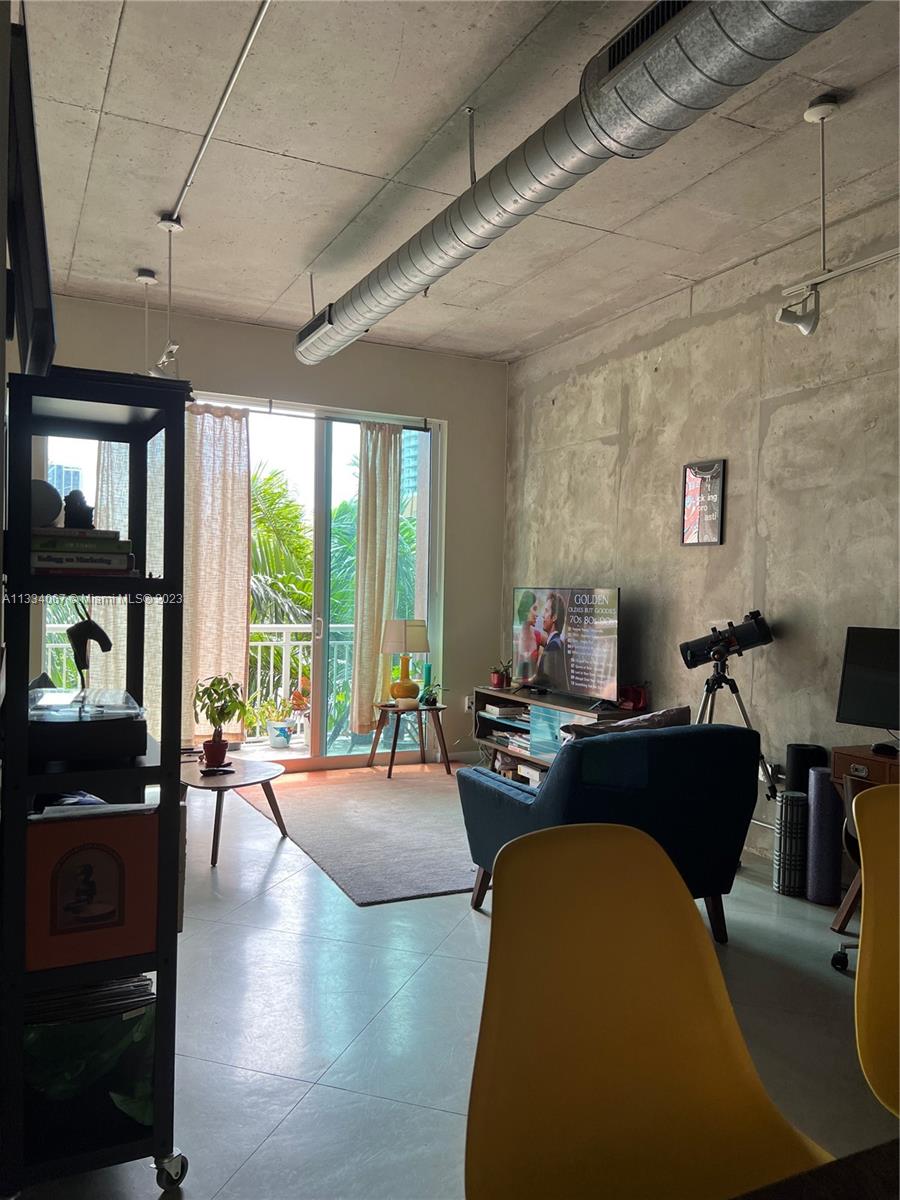 2001 Biscayne Boulevard, Unit 2503 Miami, FL 33137 - Photo 4 of 22 a living room with furniture and a large window