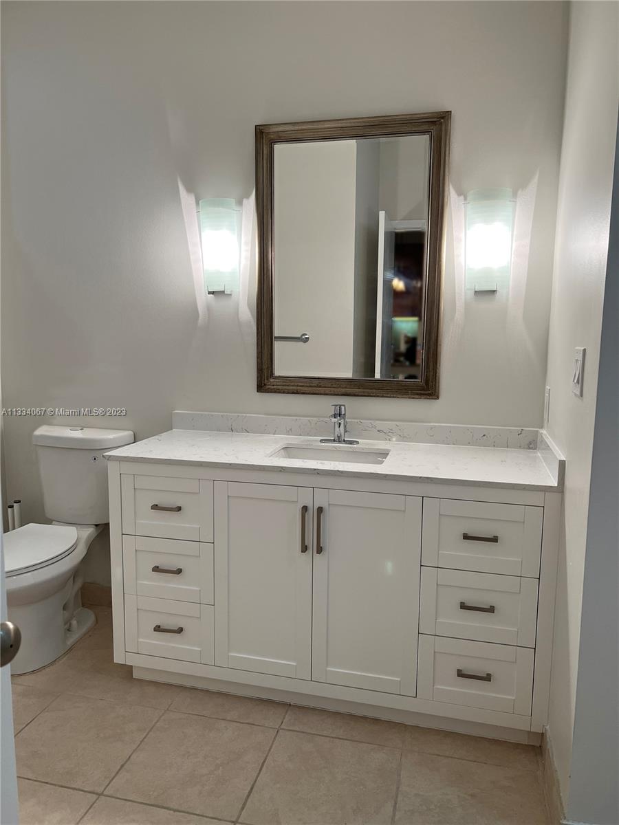 2001 Biscayne Boulevard, Unit 2503 Miami, FL 33137 - Photo 9 of 22 a bathroom with a toilet sink and mirror