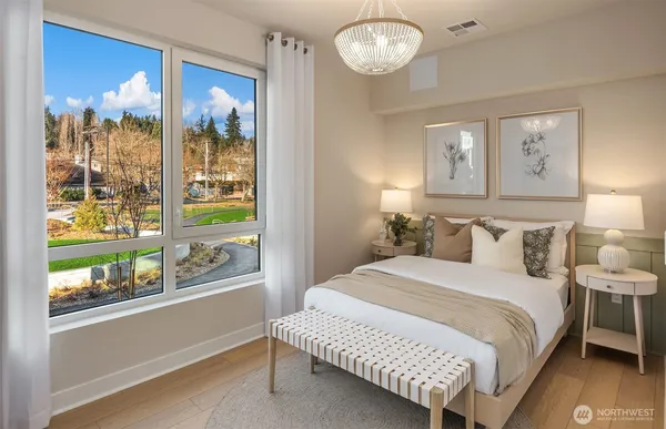 a bedroom with a large bed and a large window