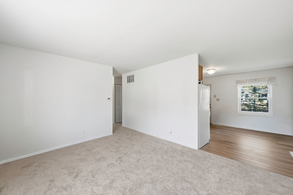 910 Meadow Lane Streamwood, IL 60107 - Photo 6 of 30 an empty room with wooden floor and windows