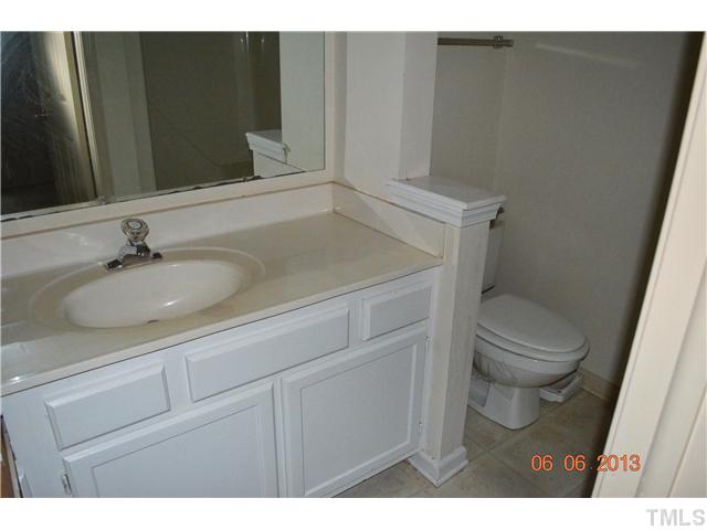 4501 Still Pines Drive Raleigh, NC 27613 - Photo 11 of 13 a bathroom with a sink toilet and vanity