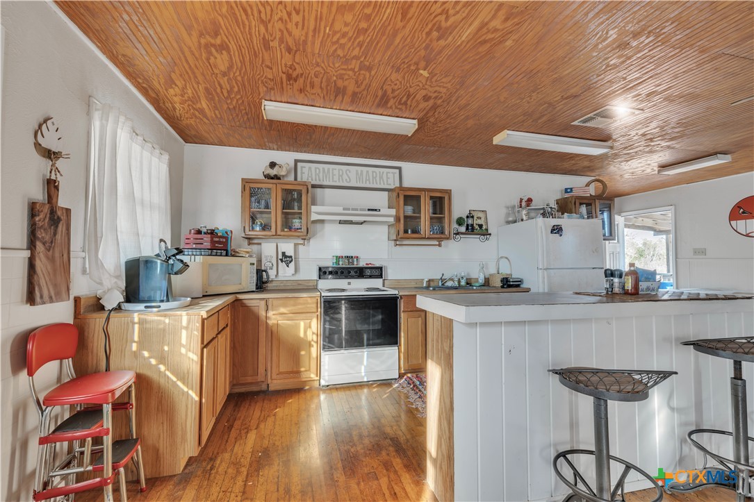 895 Patterson Road Flatonia, TX 78941 - Photo 6 of 21 a kitchen with stainless steel appliances granite countertop a stove and cabinets