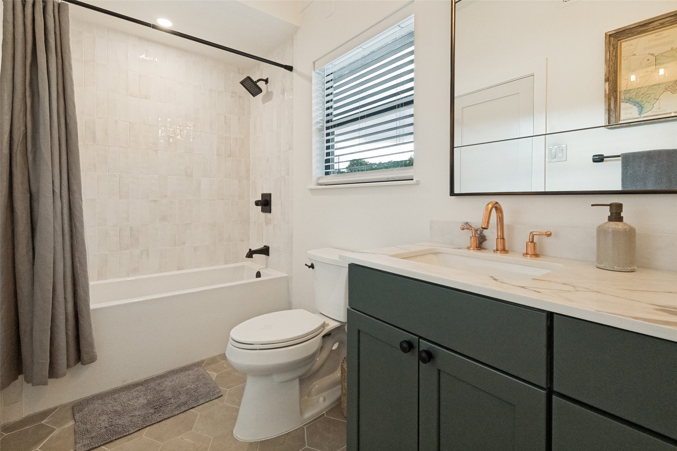 303 Lago Verde Road Austin, TX 78734 - Photo 26 of 39 Modern fixtures and hexagonal tile create a contemporary bathroom aesthetic.