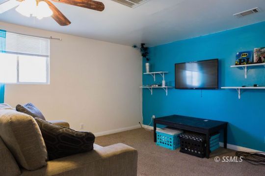 308 West Howell Avenue Ridgecrest, CA 93555 - Photo 15 of 32 a room with furniture and a flat screen tv