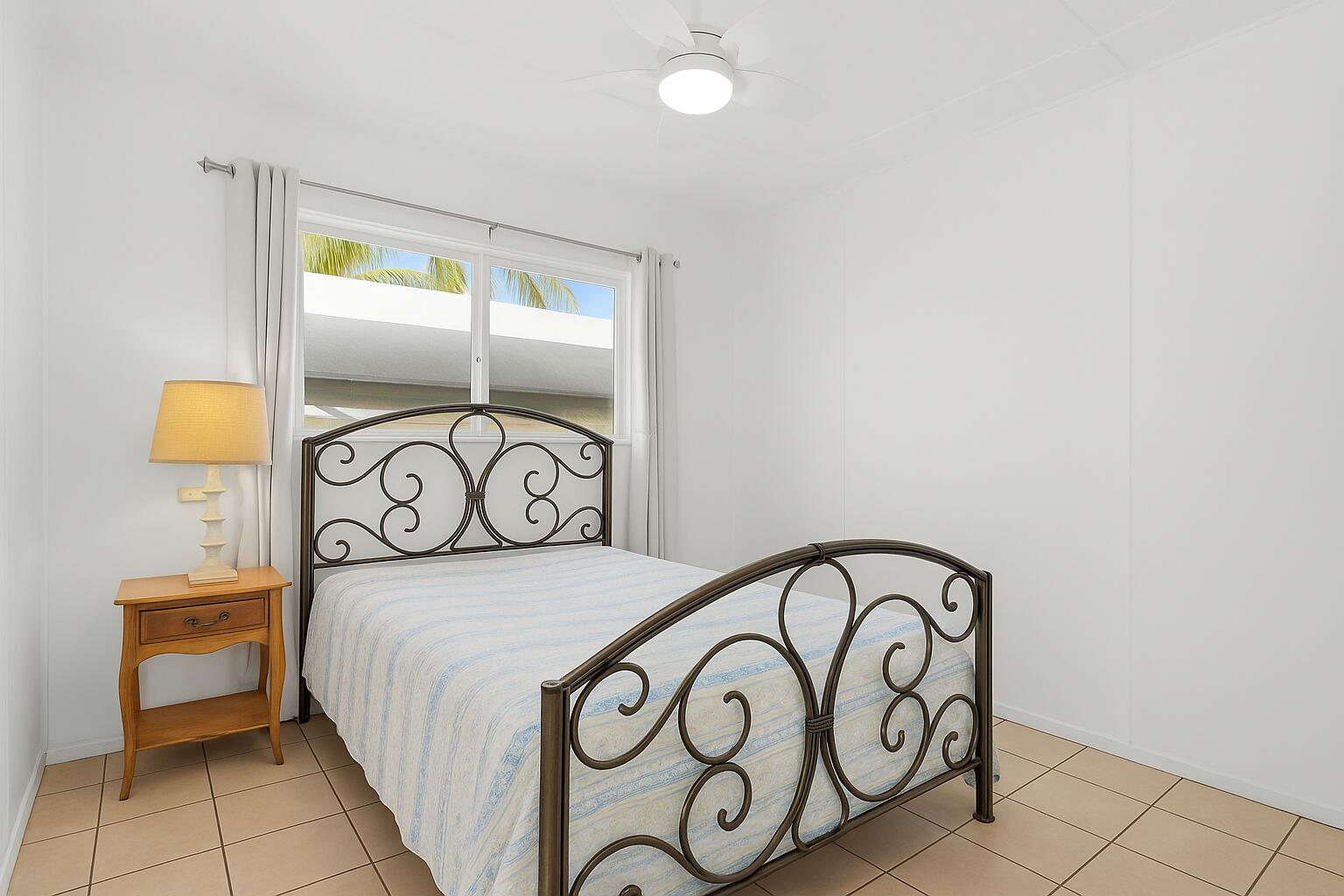20 Palm Drive Key Largo, FL 33037 - Photo 14 of 47 a bedroom with a white bed and a table