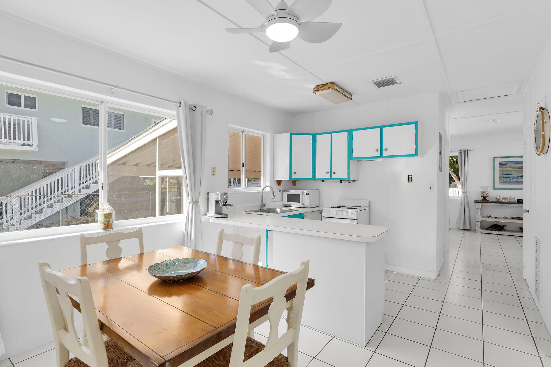 20 Palm Drive Key Largo, FL 33037 - Photo 17 of 47 a kitchen with a sink a stove and chairs