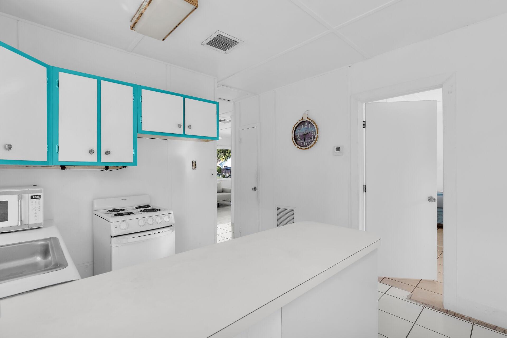 20 Palm Drive Key Largo, FL 33037 - Photo 20 of 47 a kitchen with stainless steel appliances a refrigerator sink and cabinets