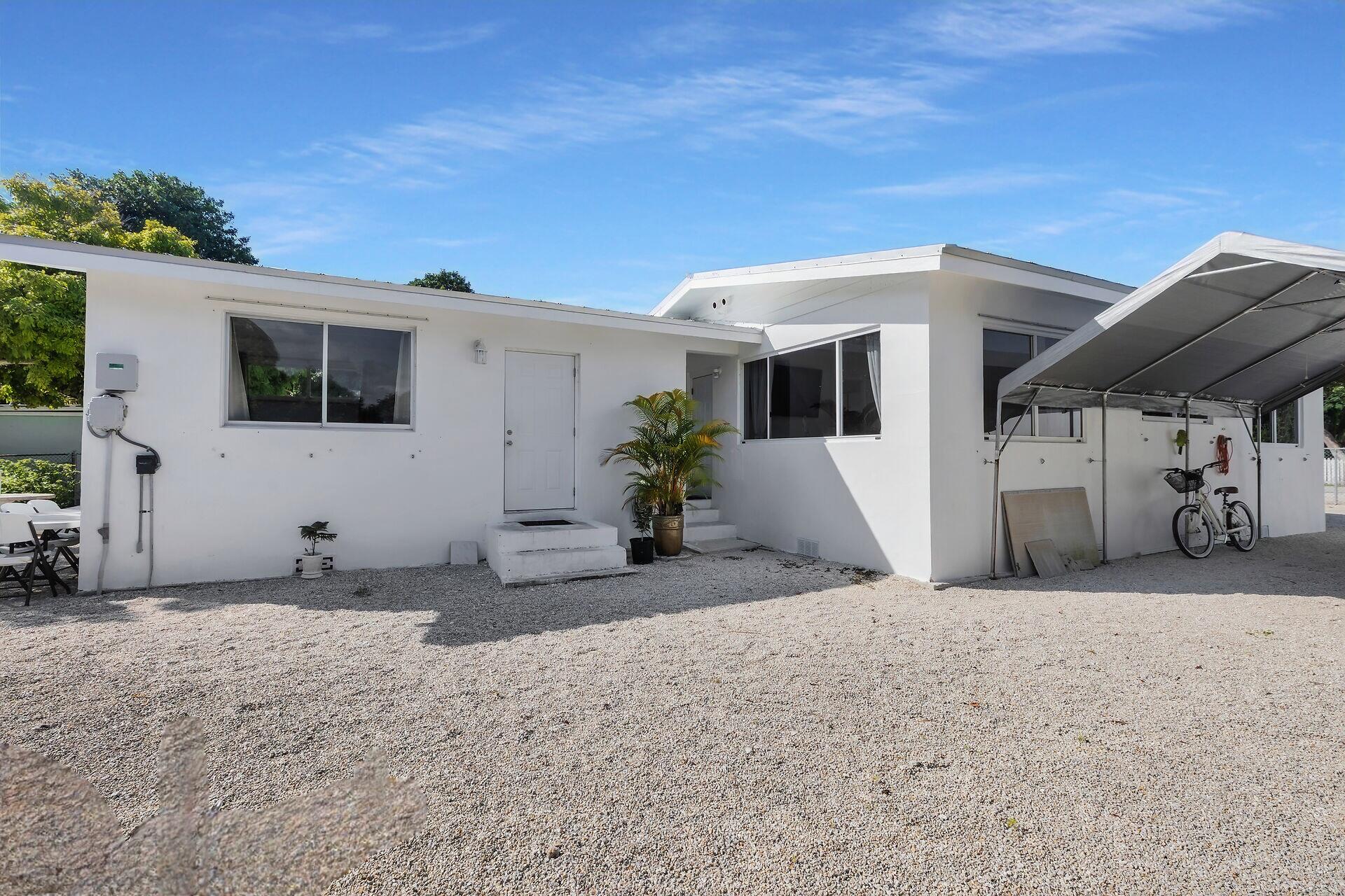 20 Palm Drive Key Largo, FL 33037 - Photo 30 of 47 a view of a house with a patio