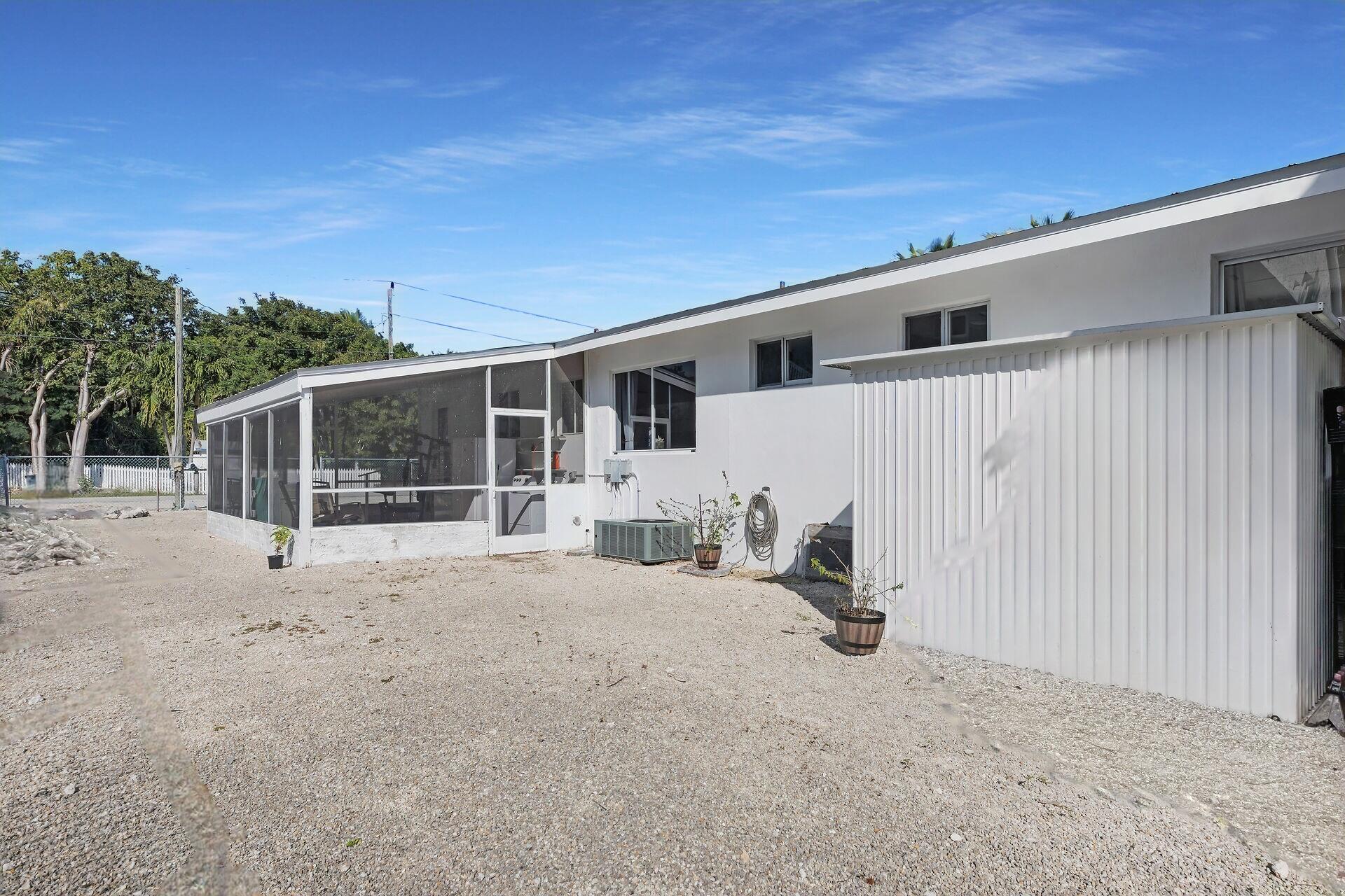 20 Palm Drive Key Largo, FL 33037 - Photo 34 of 47 a view of a house with backyard and sitting area