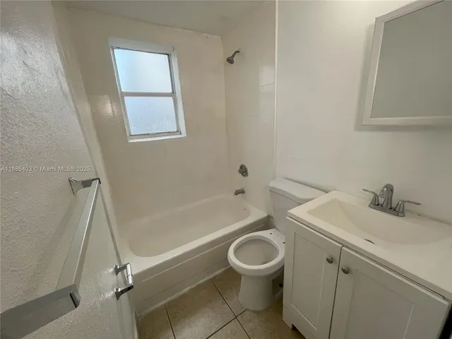 a white toilet sitting next to a white sink
