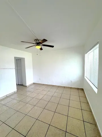 a view of an empty room and a window
