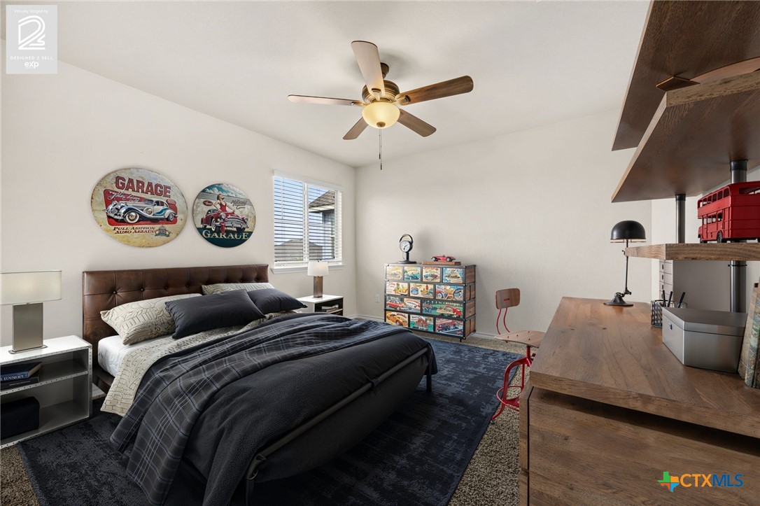 5927 Galveston Road Belton, TX 76513 - Photo 30 of 39 a bedroom with a bed and a chandelier