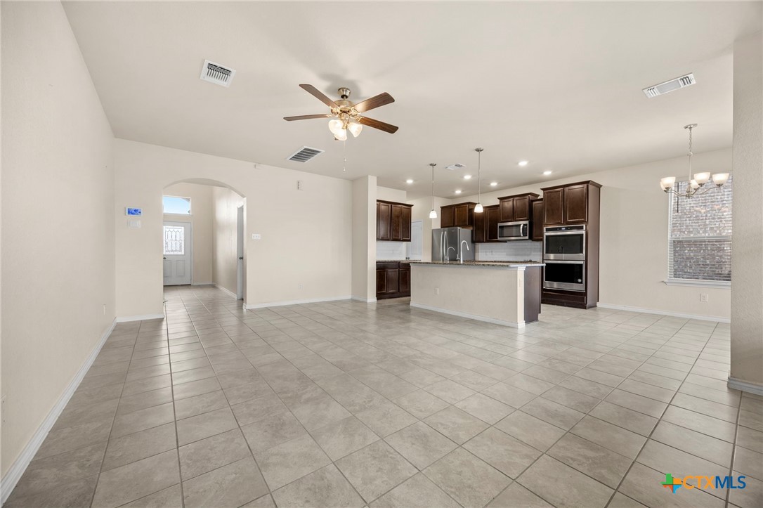 5927 Galveston Road Belton, TX 76513 - Photo 6 of 39 a view of a kitchen with kitchen island stainless steel appliances refrigerator sink and cabinets