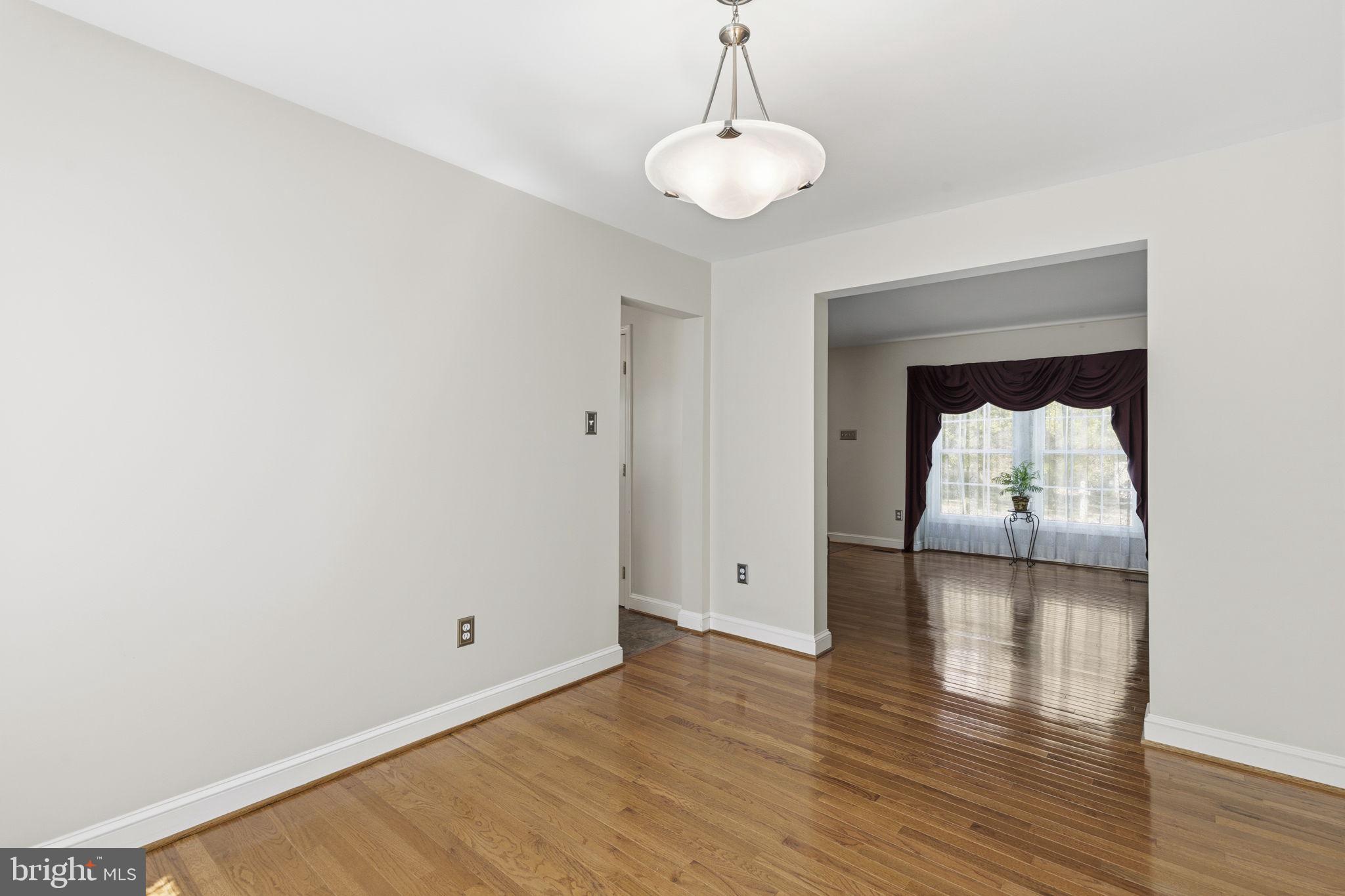 533 Inglewood Road Bel Air, MD 21015 - Photo 10 of 52 a view of a room with wooden floor table and a chandelier