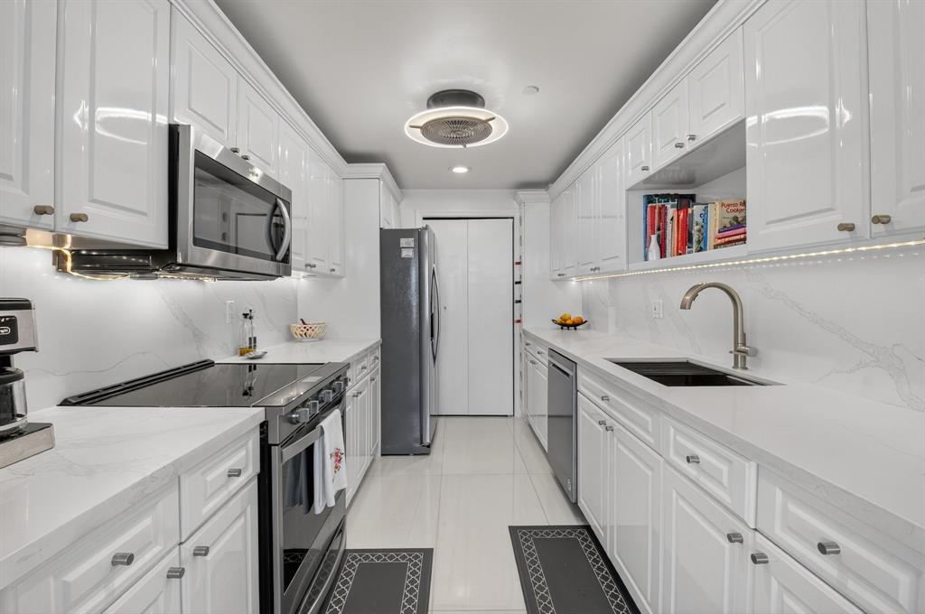899 Jeffery Street, Unit 710 Boca Raton, FL 33487 - Photo 11 of 44 a kitchen with stainless steel appliances granite countertop a sink stove and cabinets