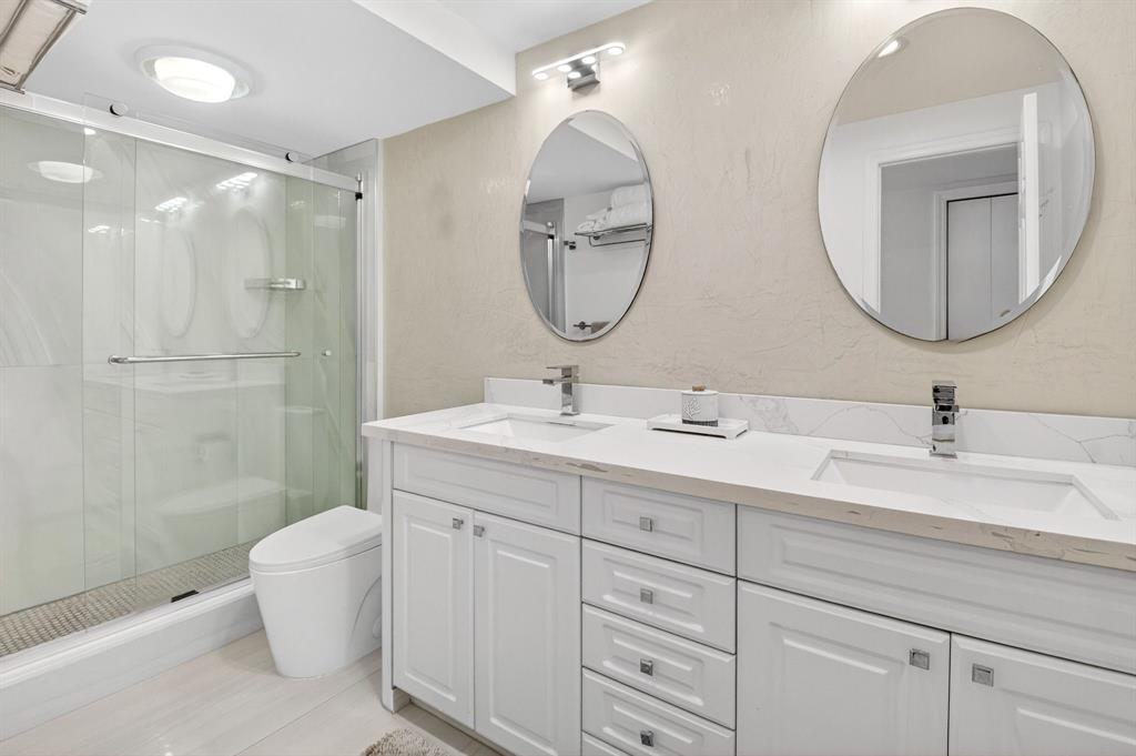 899 Jeffery Street, Unit 710 Boca Raton, FL 33487 - Photo 13 of 44 a bathroom with a double vanity sink mirror and toilet