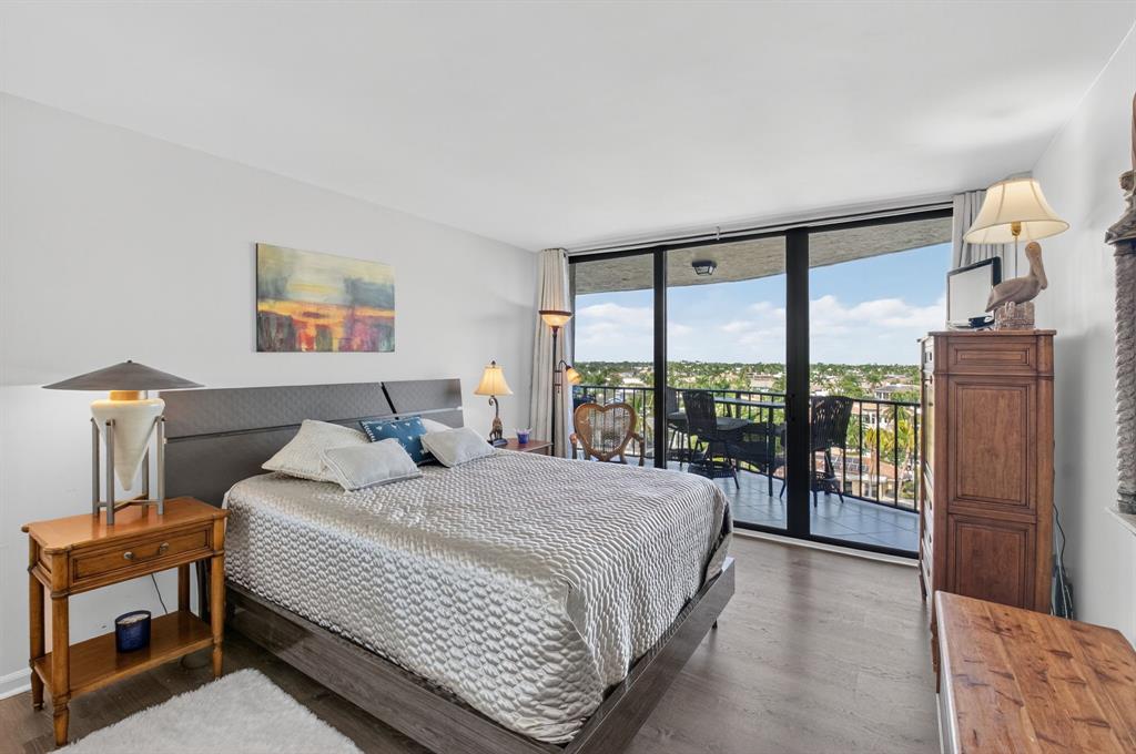 899 Jeffery Street, Unit 710 Boca Raton, FL 33487 - Photo 19 of 44 a bedroom with a large bed and a night stand